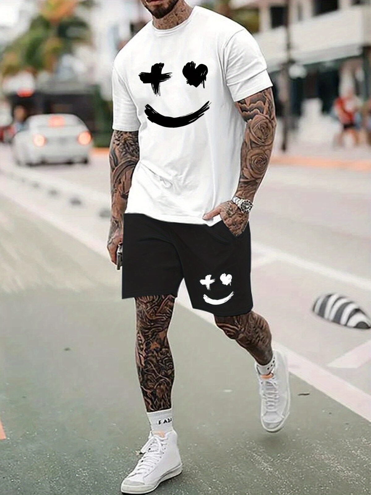 Model wearing the Newness Urban Edge Smiley Face Shorts Set a trendy mens outfit featuring a stylish smiley face graphic and comfortable modern fit perfect for vacation or workouts