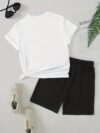 Model wearing the Newness Urban Edge Smiley Face Shorts Set a trendy mens outfit featuring a stylish smiley face graphic and comfortable modern fit perfect for vacation or workouts