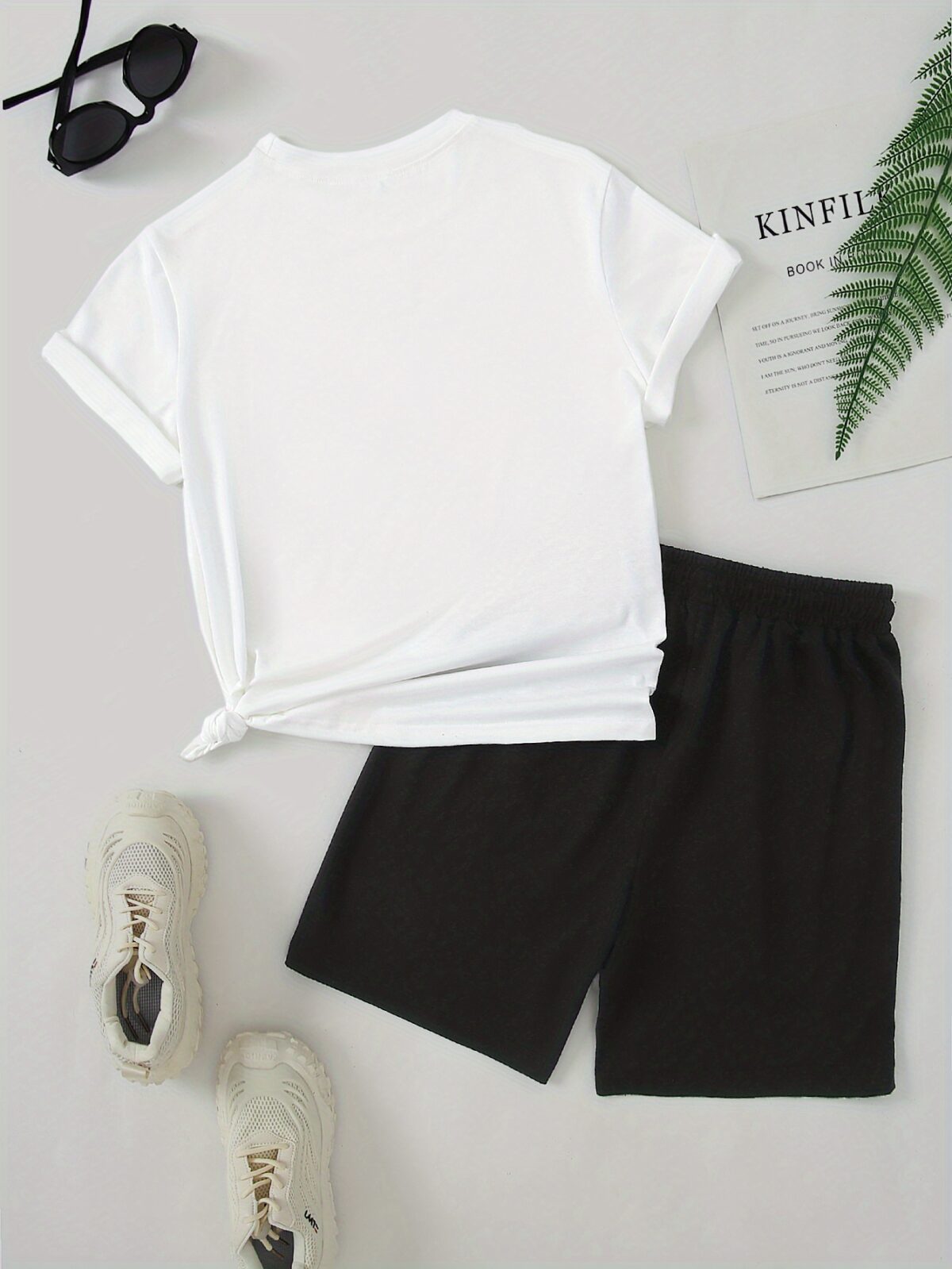 Model wearing the Newness Urban Edge Smiley Face Shorts Set a trendy mens outfit featuring a stylish smiley face graphic and comfortable modern fit perfect for vacation or workouts