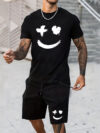Model wearing the Newness Urban Edge Smiley Face Shorts Set a trendy mens outfit featuring a stylish smiley face graphic and comfortable modern fit perfect for vacation or workouts