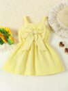 Adorable little girl wearing a stylish navy and white striped summer dress perfect for playdates and picnics She is smiling and looks happy