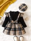 Adorable girl wearing a red and white plaid dress and matching beret Perfect for spring or fall