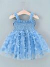 Adorable baby girl wearing a Flutterby Mesh Butterfly Dress a perfect summer outfit from Newness