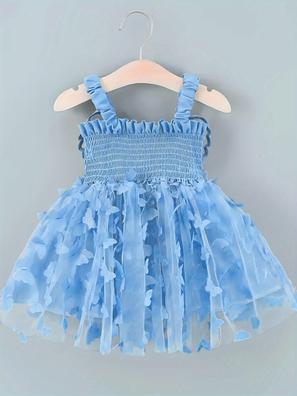 Adorable baby girl wearing a Flutterby Mesh Butterfly Dress a perfect summer outfit from Newness
