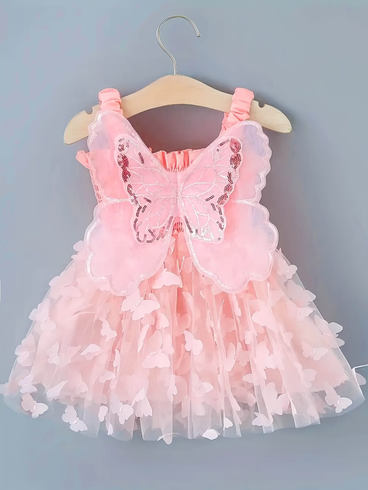 Adorable baby girl wearing a Flutterby Mesh Butterfly Dress a perfect summer outfit from Newness