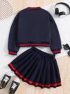Stylish preppy varsity jacket and skirt set in navy and cream modeled on a student in a school setting