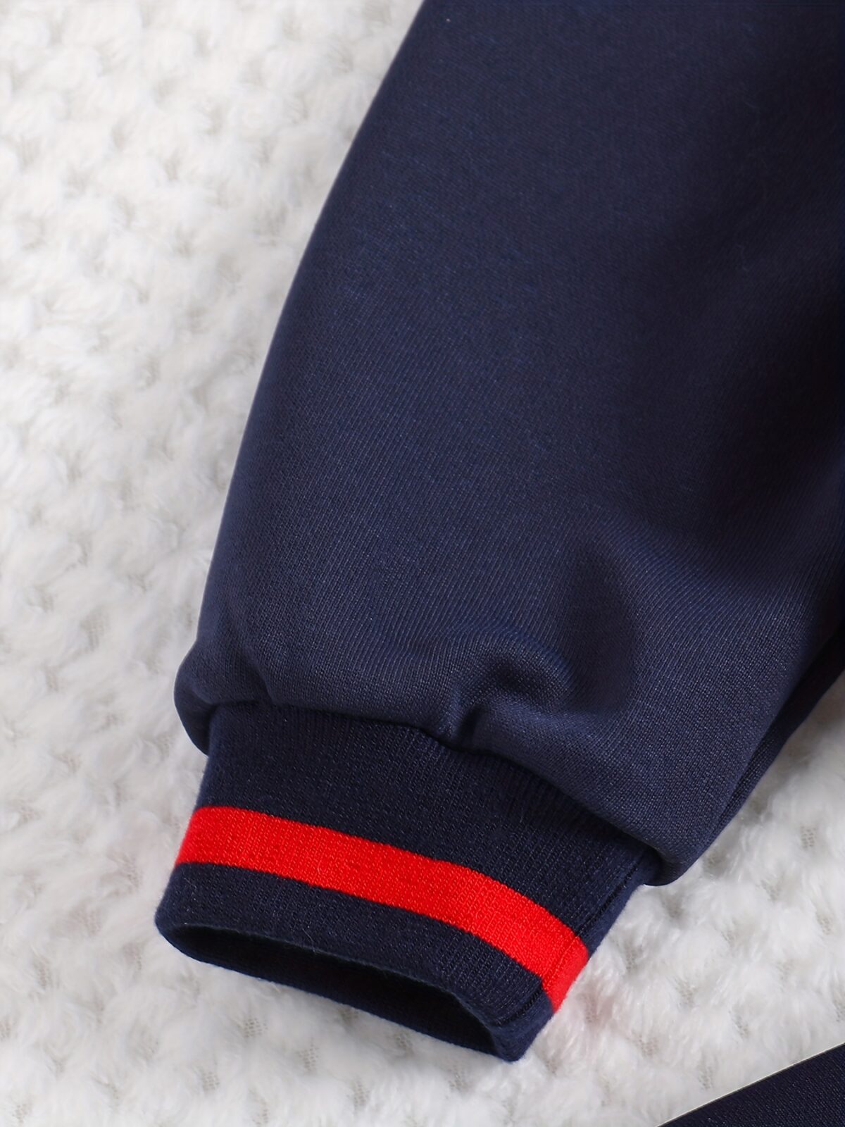 Stylish preppy varsity jacket and skirt set in navy and cream modeled on a student in a school setting