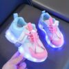 Kids GUANGLAN Nova Glow Shoes lighting up at night showcasing their lightweight and durable design Perfect for nighttime play and adventures