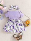 Adorable baby girl wearing a Summer Bloom floral dress perfect for summer