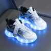 Kids GUANGLAN Nova Glow Shoes lighting up at night showcasing their lightweight and durable design Perfect for nighttime play and adventures