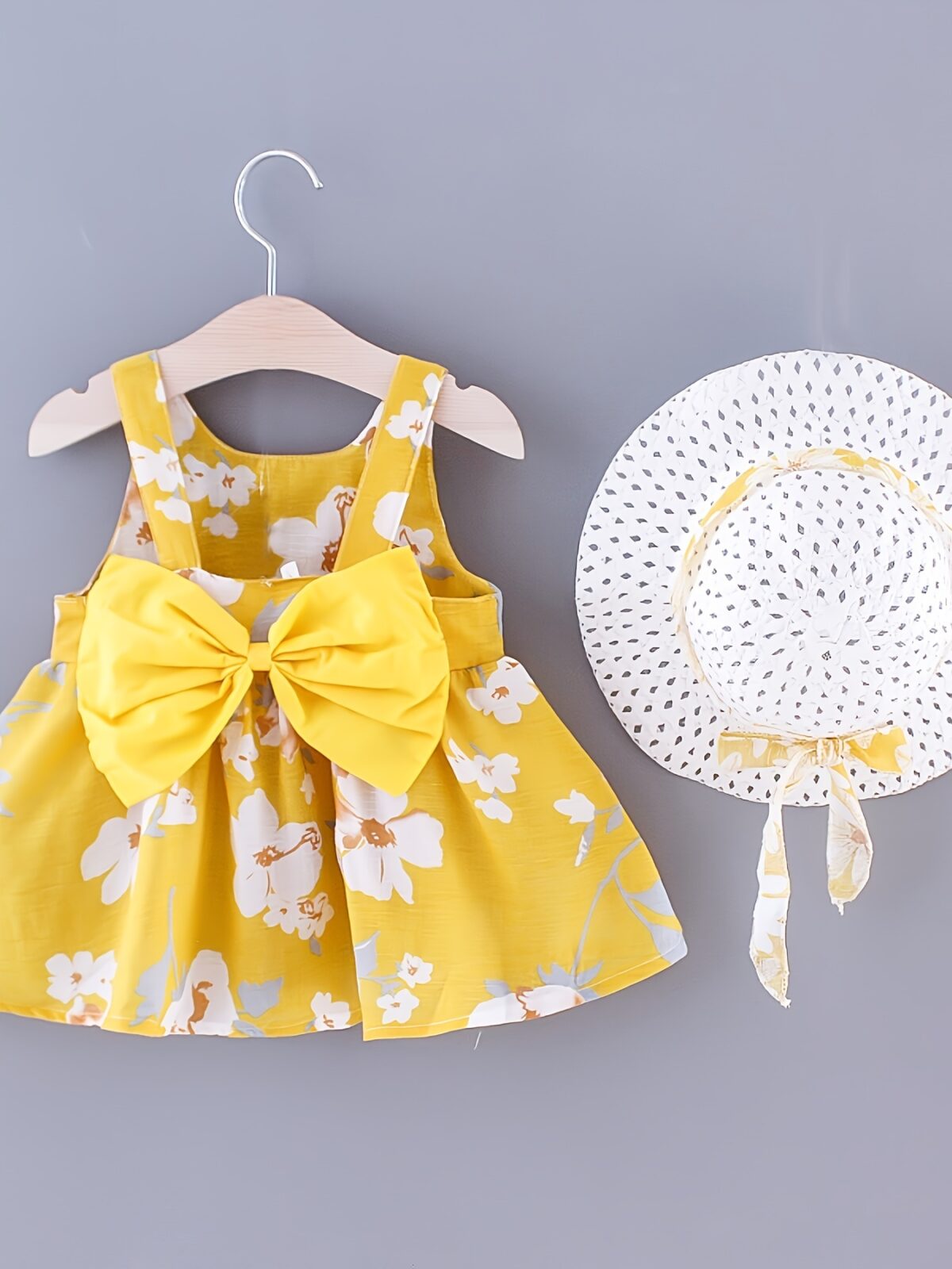 Baby girl wearing adorable Newness Sunny Days floral print dress