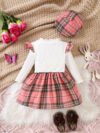 Adorable girl wearing a red and white plaid dress and matching beret Perfect for spring or fall