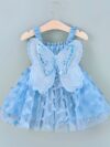 Adorable baby girl wearing a Flutterby Mesh Butterfly Dress a perfect summer outfit from Newness