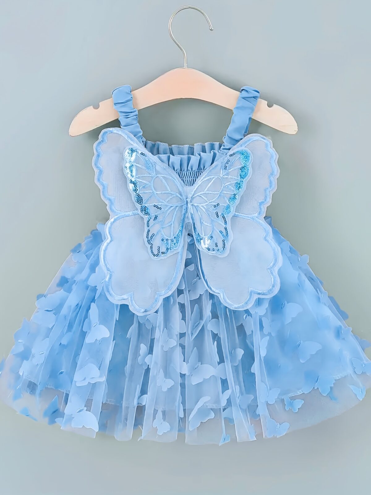 Adorable baby girl wearing a Flutterby Mesh Butterfly Dress a perfect summer outfit from Newness
