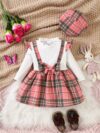 Adorable girl wearing a red and white plaid dress and matching beret Perfect for spring or fall