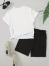 Model wearing the Newness Urban Edge Smiley Face Shorts Set a trendy mens outfit featuring a stylish smiley face graphic and comfortable modern fit perfect for vacation or workouts