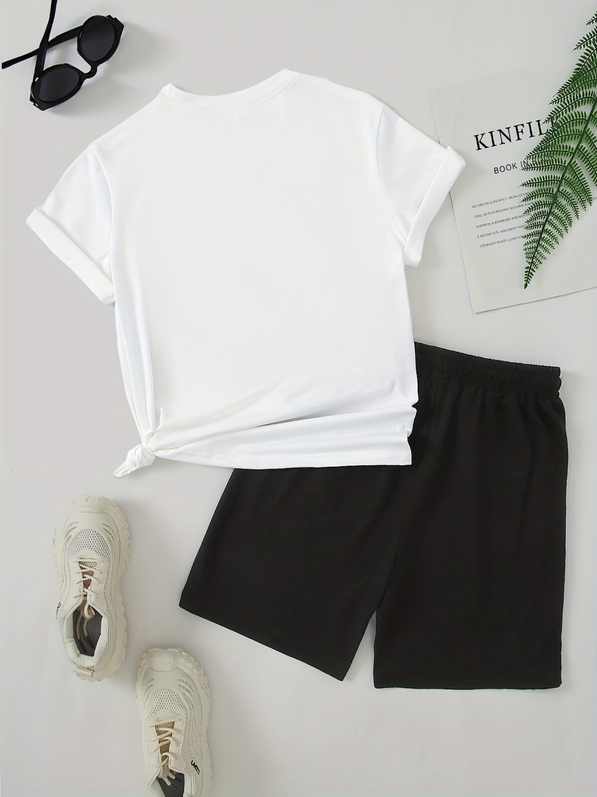 Model wearing the Newness Urban Edge Smiley Face Shorts Set a trendy mens outfit featuring a stylish smiley face graphic and comfortable modern fit perfect for vacation or workouts