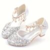A pair of elegant Starlight Sparkle Girls Princess Heels perfect for weddings and special events The shoes feature sparkling embellishments and a delicate design