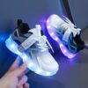 Kids GUANGLAN Nova Glow Shoes lighting up at night showcasing their lightweight and durable design Perfect for nighttime play and adventures