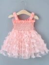 Adorable baby girl wearing a Flutterby Mesh Butterfly Dress a perfect summer outfit from Newness