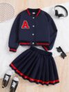 Stylish preppy varsity jacket and skirt set in navy and cream modeled on a student in a school setting