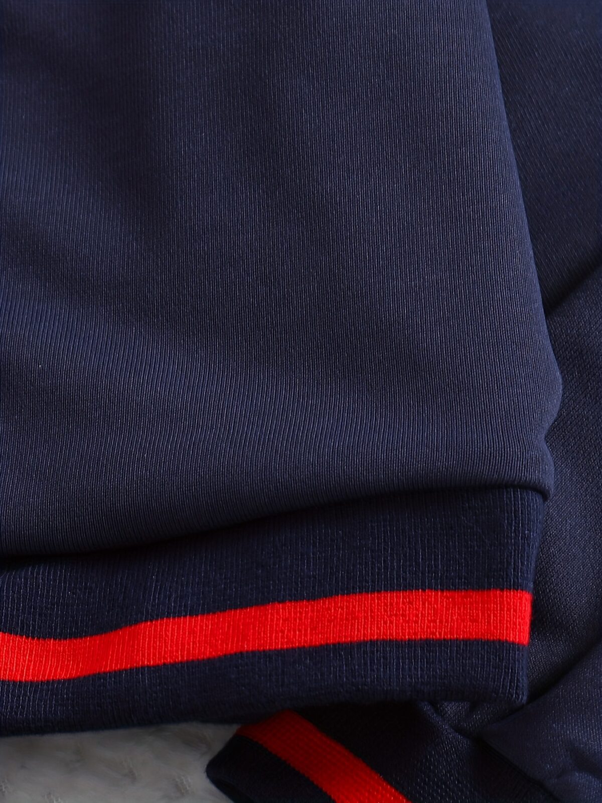 Stylish preppy varsity jacket and skirt set in navy and cream modeled on a student in a school setting