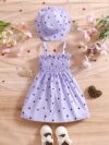 Girl wearing adorable Summer Bloom heart print dress and matching hat set