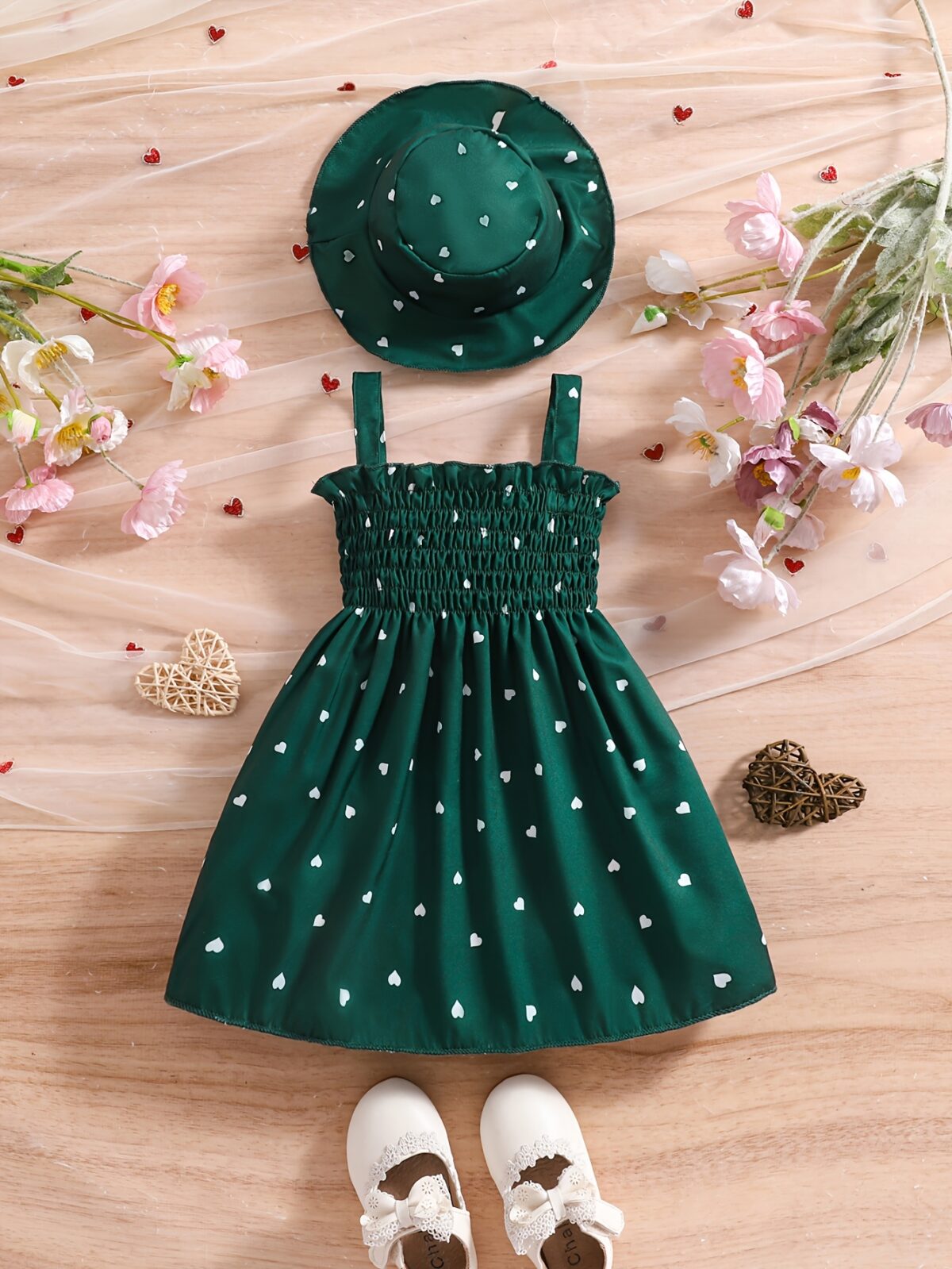 Girl wearing adorable Summer Bloom heart print dress and matching hat set