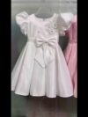 Adorable girl twirling in a lavender colored party dress perfect for birthdays and special occasions The dress features exquisite detailing and a flattering silhouette
