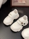 Adorable kids Playful Striped Sneakers with a cute bear charm showcasing Newnesss stylish and comfortable design