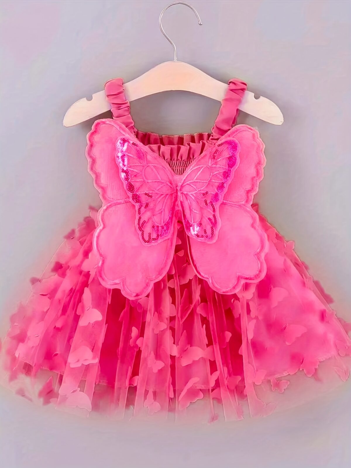 Adorable baby girl wearing a Flutterby Mesh Butterfly Dress a perfect summer outfit from Newness