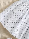 Adorable little girl twirling in a charming summer polka dot dress perfect for birthdays and special occasions