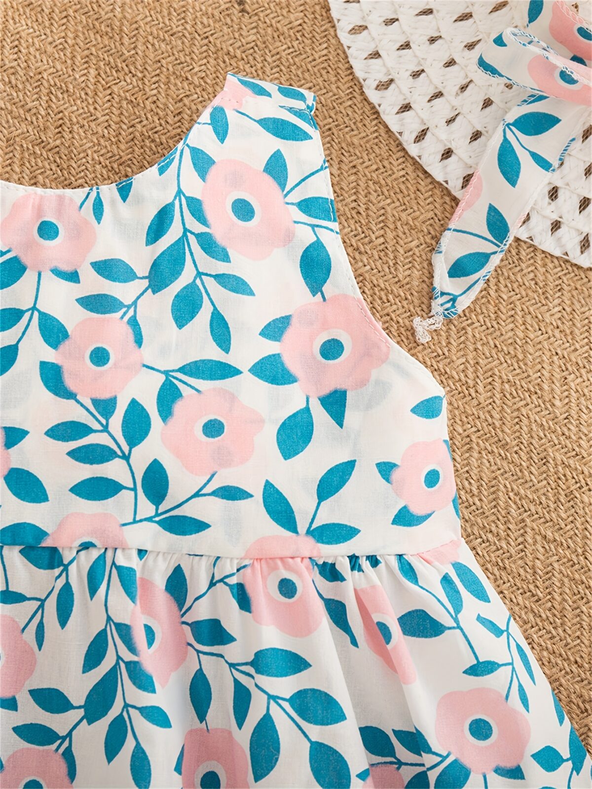 Adorable girl wearing a beautiful floral print summer dress perfect for a beach party