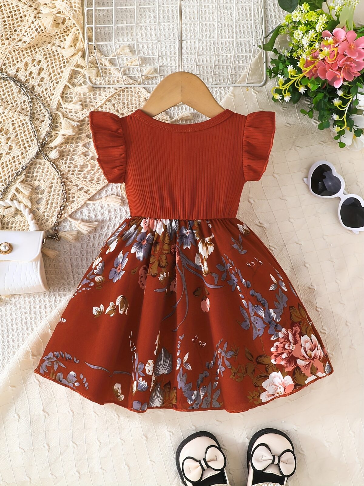 Adorable girl wearing a vibrant Summer Bloom floral print dress perfect for summer The dress features a playful colorful floral pattern