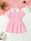 Adorable baby girl in a charming rose patterned summer dress perfect for playdates or special occasions