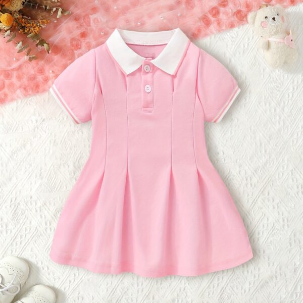 Adorable baby girl in a charming rose patterned summer dress perfect for playdates or special occasions