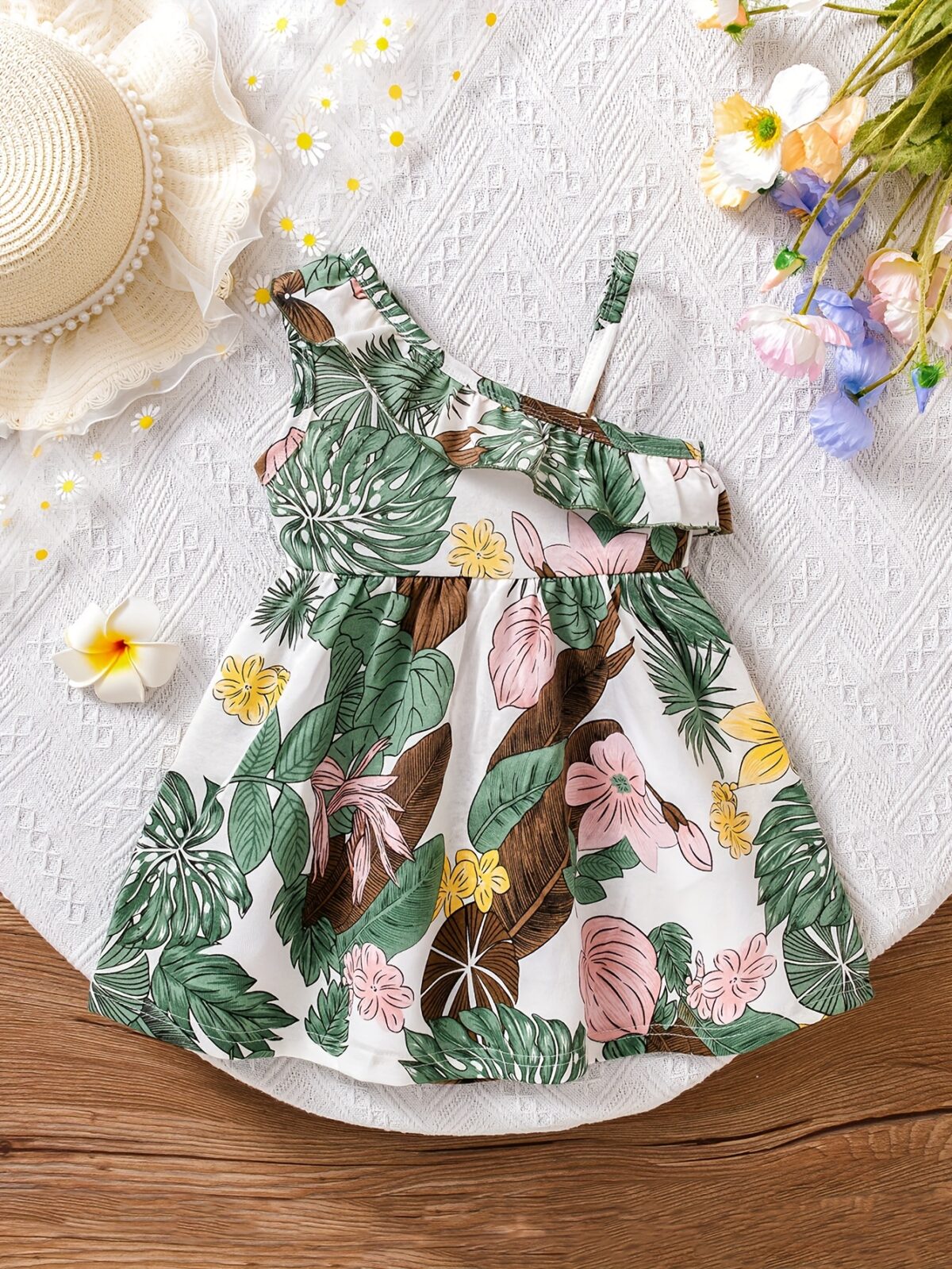 Baby girl wearing adorable Island Bloom floral print dress smiling
