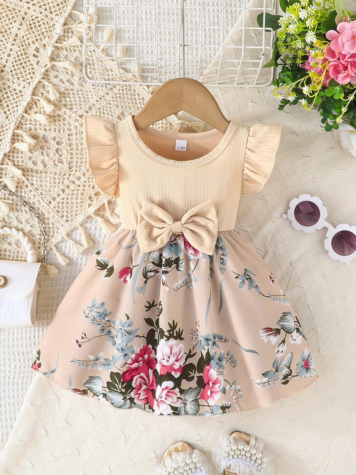 Adorable girl wearing a vibrant Summer Bloom floral print dress perfect for summer The dress features a playful colorful floral pattern