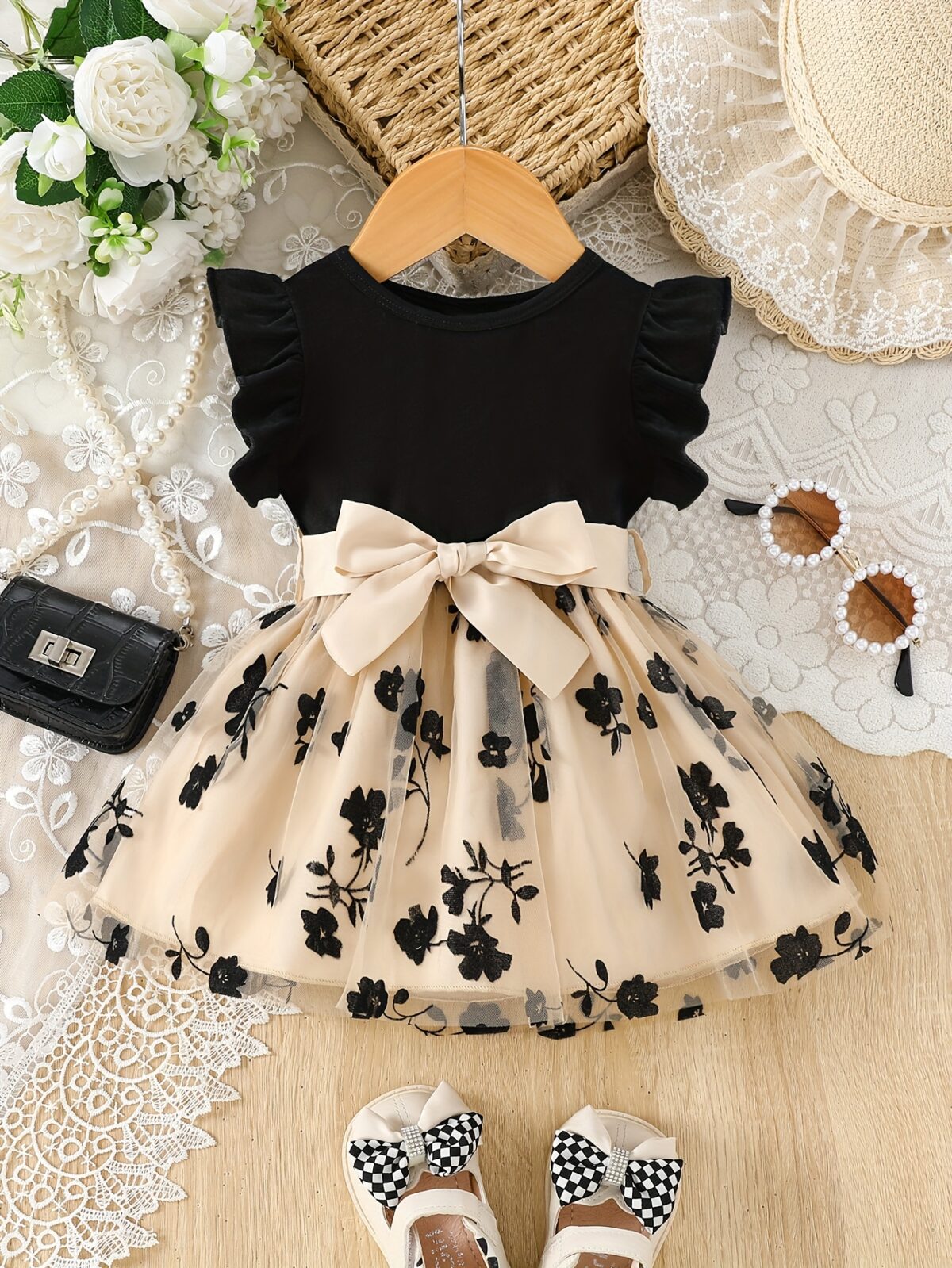 Adorable little girl twirling in a beautiful summer floral mesh dress from Newness The dress is lightweight and perfect for warm weather