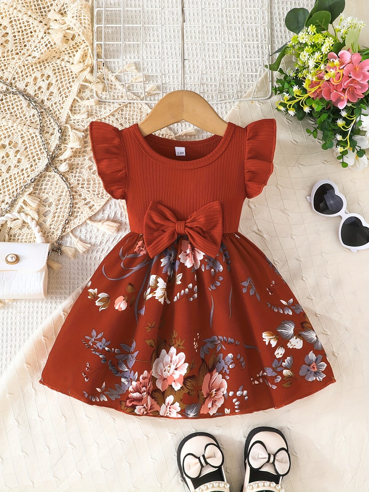 Adorable girl wearing a vibrant Summer Bloom floral print dress perfect for summer The dress features a playful colorful floral pattern