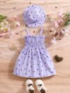Girl wearing adorable Summer Bloom heart print dress and matching hat set