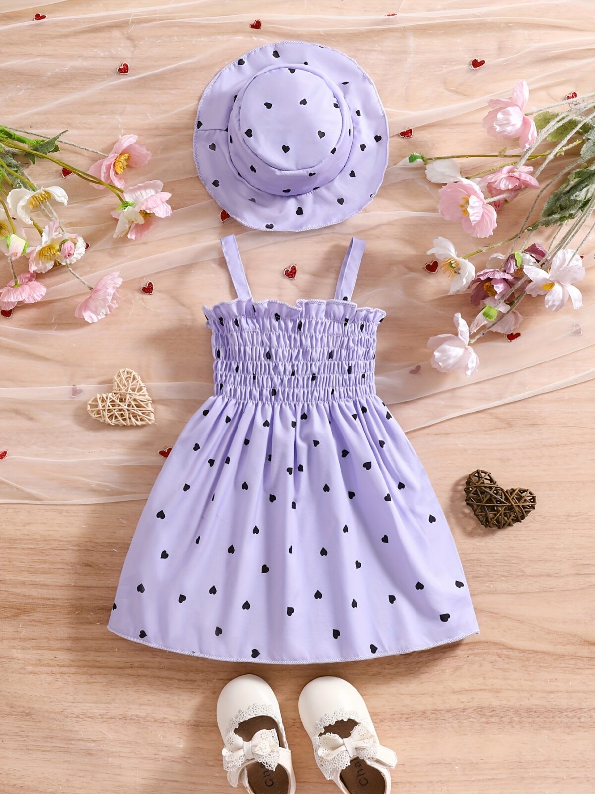 Girl wearing adorable Summer Bloom heart print dress and matching hat set