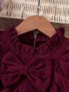 Adorable baby girl wearing a charming corduroy dress perfect for playtime or special occasions