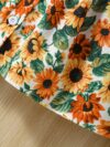 Baby girl wearing an adorable sunflower floral print dress perfect for summer