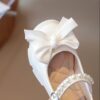 Celestial Bow  Pearl Girls Dress Shoes by Newness Elegant white dress shoes with a delicate bow and pearls perfect for weddings and parties