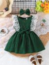 Toddler girl wearing a charming emerald green summer dress ideal for playing outdoors