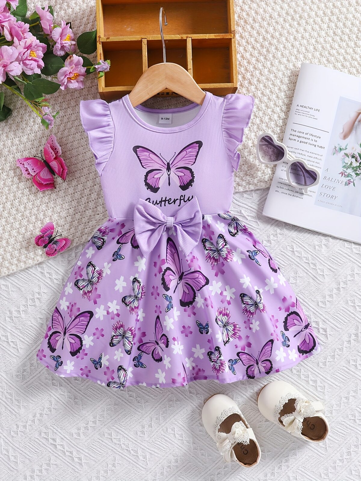 Adorable baby girl in a lavender butterfly dress perfect for summer Newness
