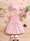 Girl wearing adorable Summer Bloom heart print dress and matching hat set