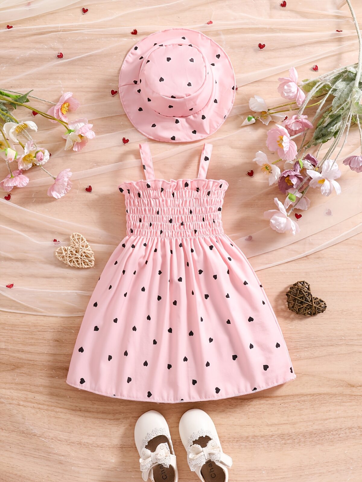 Girl wearing adorable Summer Bloom heart print dress and matching hat set