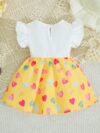 Adorable baby girl wearing a summer heart print dress perfect for school and special occasions